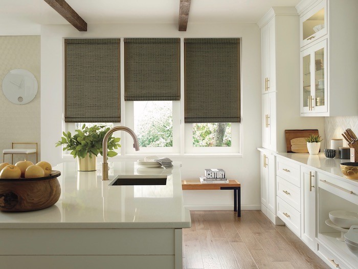 Kitchen with white counter and modern. Shades in the window